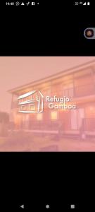 a sign for a refuge camino logo on a building at REFUGIO GAMBOA in Castro