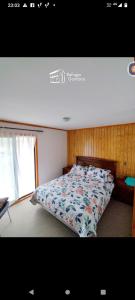 a bedroom with a bed with a quilt on it at REFUGIO GAMBOA in Castro