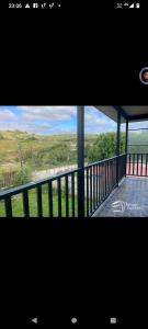 a picture of a balcony with a view of the ocean at REFUGIO GAMBOA in Castro