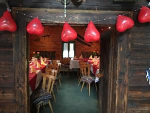 a restaurant with red hearts hanging from the ceiling at Waldrestaurant VIDA in Kapfenberg