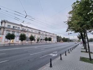 an empty street with buildings on the side of the road at Boulevard Ultra Central Apartments in the heart of Chisinau in Chişinău