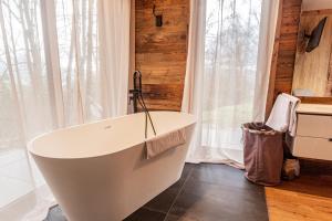 a bath tub in a bathroom with a window at Chalet Dinkel in Niedernsill in Niedernsill