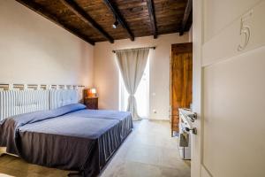 a bedroom with a bed and a large window at Residenza Mistral in Rende