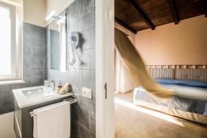 a bathroom with a sink and a bed at Residenza Mistral in Rende +42 photos