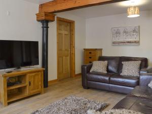 a living room with a couch and a flat screen tv at Snowdon - Uk6627 in Pen-y-groes