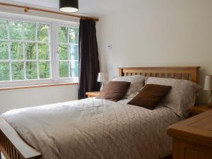 a bedroom with a bed and a large window at Snowdon - Uk6627 in Pen-y-groes