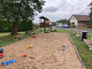 a sandpit with a playground and a swingukongukongukongukongukong at Adela´s Czech Village House in Všejany