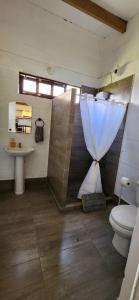 a bathroom with a toilet and a sink at Fundo Don Ricardo in Lima