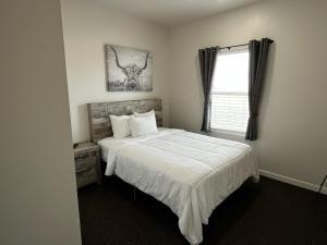 a bedroom with a bed with a skull picture on the wall at Longhorn Flats in Loving