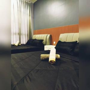 En eller flere senge i et værelse på D'RZ Muslim Seaview Homestay Bali Residence