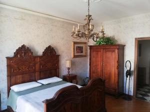 a bedroom with a wooden bed and a chandelier at Yellow House in Turin