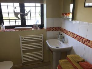 a small bathroom with a sink and a toilet at NIGHTINGALE B&B in Pershore +26 photos
