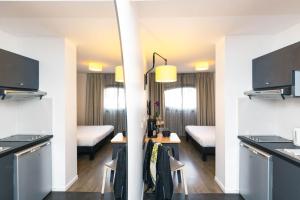 um quarto com uma cozinha e uma sala de jantar em Aparthotel Adagio Access Nancy Centre em Nancy