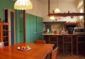 a kitchen with a table with a bowl of fruit on it at Villa Casagrande in Vittorio Veneto