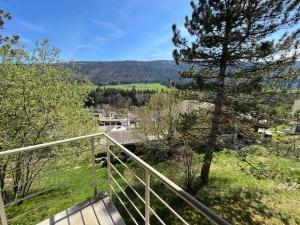 a view from the balcony of a house with a tree at the Jad B&B in Comoret