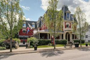 a row of houses on a street with trees at 871 shefford suite 207 3chambres in Bromont