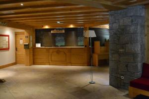 a living room with a stone pillar and a room with a stone wall at Pour 4 pers résidence 4* au pied des pistes in Lanslebourg-Mont-Cenis