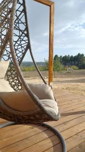 a wicker chair sitting on a wooden deck at Quinta da Carreirinha in Vila Franca das Naves
