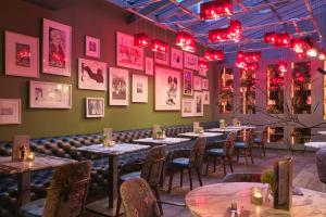 a row of tables in a restaurant with red lights at Tigerlily in Edinburgh