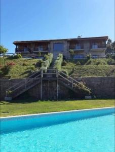 a house on top of a hill with a swimming pool at Retiro de Basto in Celorico de Basto