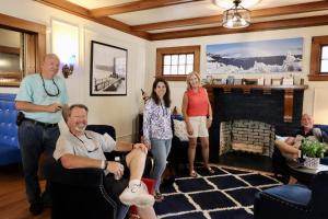 a group of people standing in a living room at The Butler House Bed & Breakfast in Niagara Falls