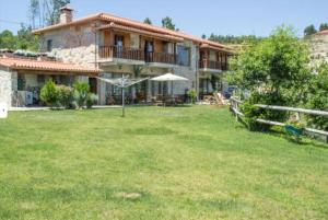 a house with a large yard in front of it at Retiro de Basto in Celorico de Basto