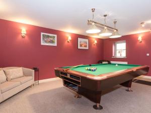 a living room with a pool table and a couch at Highbury Annexe in Frampton on Severn