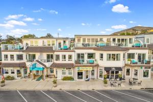 an aerial view of a building with a parking lot at Pier View Suites - Townhouse A in Cayucos