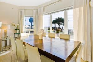 a dining room with a wooden table and chairs at Pier View Suites - Pacific Premier Suite in Cayucos