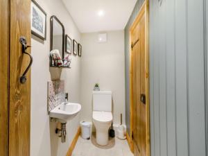 a bathroom with a white toilet and a sink at 1 Chapel Terrace in Ebberston