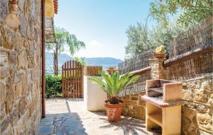 a patio with a bench and a fence at Amazing Home In S M Di Castellabate in Castellabate