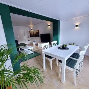 a dining room with a white table and chairs at harmony holiday in Jünkerath