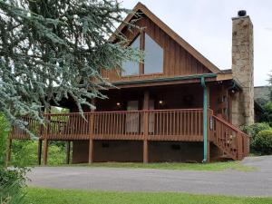 a house with a large deck on the side of it at Story Brook: Beautiful true log cabin! Close to Dollywood, State Park, and more! in Sevierville