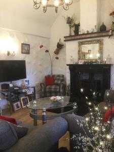 a living room with a couch and a coffee table at Tullybeggs B&B in Clifden