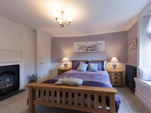 a bedroom with a bed and a fireplace at Beverley Minster House in Beverley