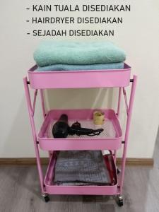 einen rosa Karren mit Handtüchern darüber in der Unterkunft Fadli HOMESTAY in Kota Bharu