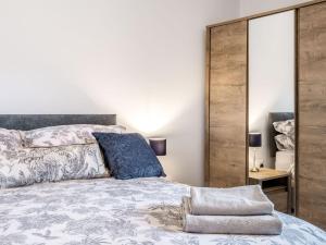 a bedroom with a king sized bed and a mirror at The Annexe hornsland Barn in Wyberton