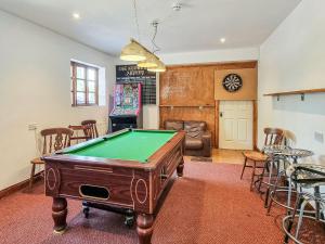 a living room with a pool table in it at The Smythy in Stawley