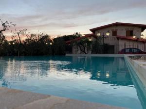 a swimming pool in front of a house at B&B MadaM in Faggiano