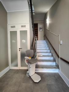 a stair lift chair in a hallway with stairs at Il Gabbiano in Termini Imerese