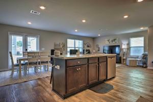 a kitchen and living room with a counter and a table at Camden Ocean Springs House Near Beaches! in Ocean Springs