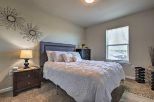 a bedroom with a bed and a lamp and a window at Camden Ocean Springs House Near Beaches! in Ocean Springs