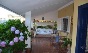 a bedroom with a bed in a room with flowers at Villa Hermes in San Ferdinando