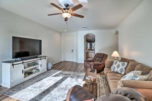 a living room with a couch and a flat screen tv at Gold Canyon House with Superstition Mountain Views! in Gold Canyon