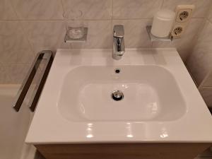 a white sink in a small bathroom with at Ferienappartement Austen in Piding