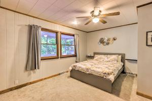 a bedroom with a bed and a ceiling fan at Harpers Ferry Cabin - Walk to Private Lake! in Harpers Ferry