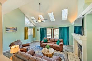 a living room with couches and a fireplace at Near Ouachita River Home with Deck in Hot Springs in Hot Springs