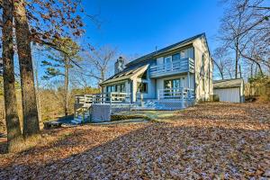 a blue house with a porch and trees at Near Ouachita River Home with Deck in Hot Springs in Hot Springs