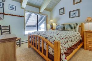 a bedroom with a wooden bed and a window at Val D'Isere 45 in Mammoth Lakes