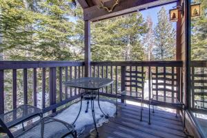 a balcony with a table and chairs on it at Val D'Isere 45 in Mammoth Lakes